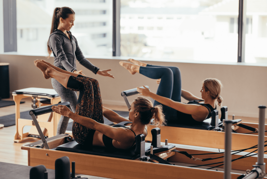 Cours collectif d'une séance de Pilates reformer.